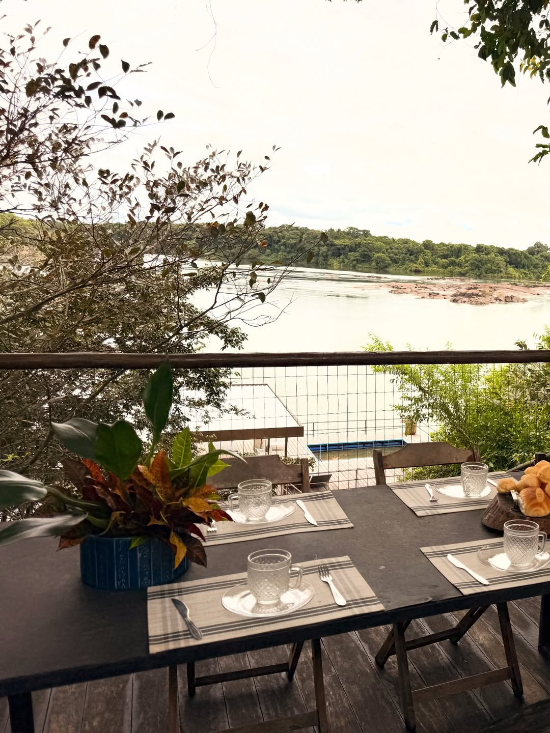 Mesa posta no tablado com vista para o rio